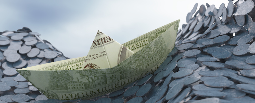 A boat made of a dollar bill floats atop a sea of coins in the analogy that shows why a cash flow forecast is so important in today